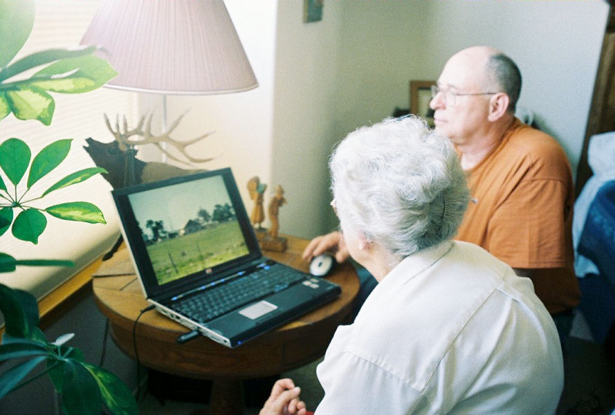 Ken shows Ophelia some pictures on his notebook computer